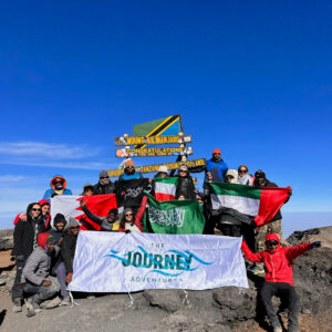 The group of adventures at the top of Mount Kilimanjaro