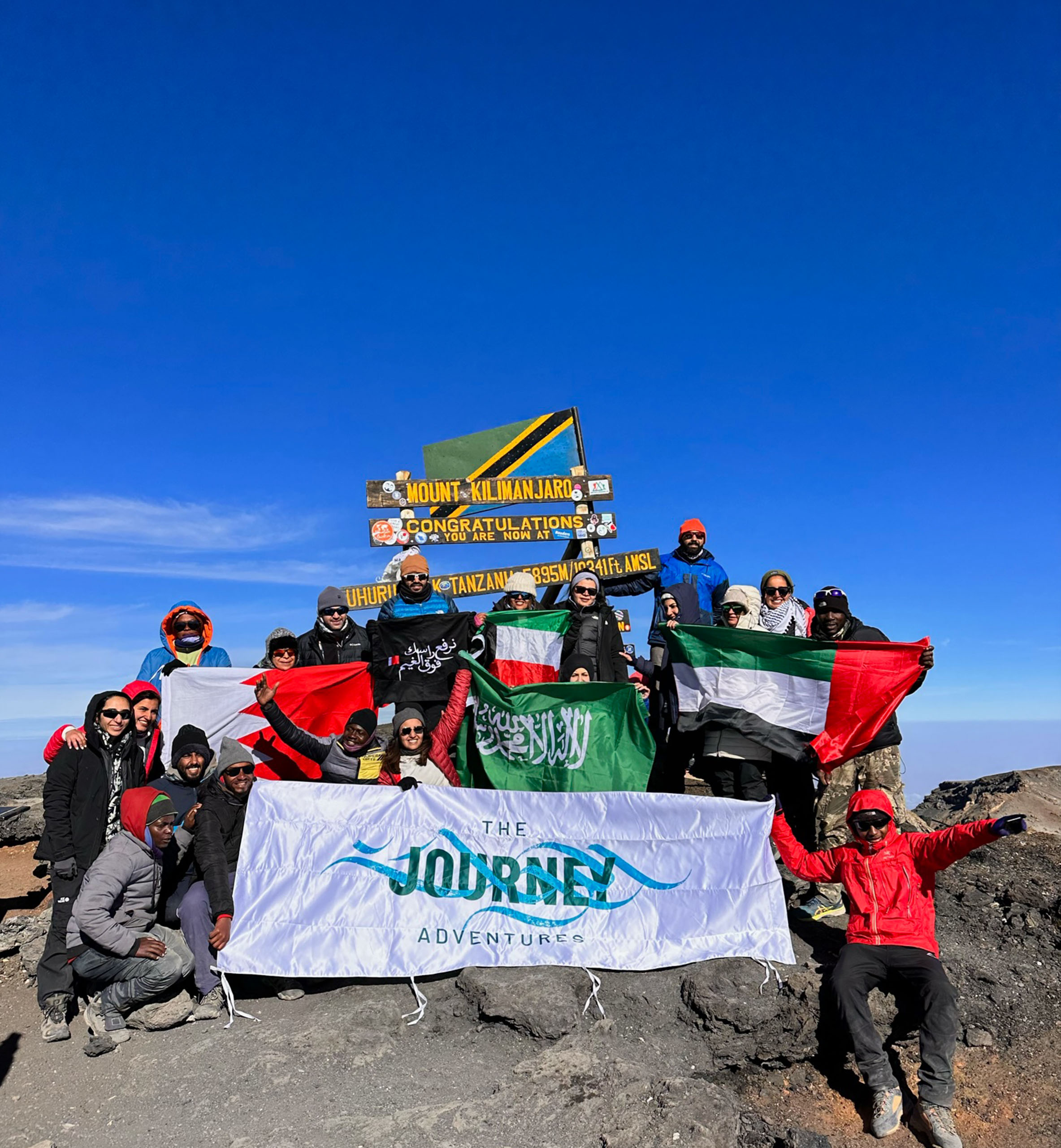 The group of adventures at the top of Mount Kilimanjaro